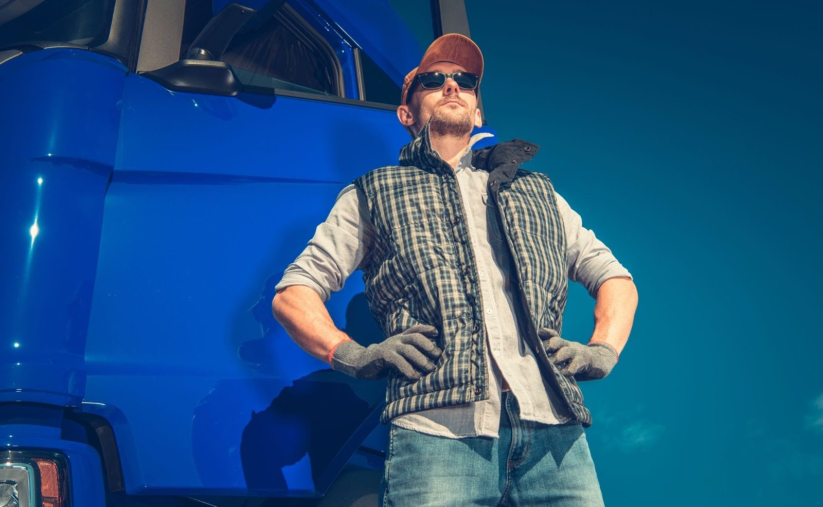 A CDL instructor standing in front of a truck.